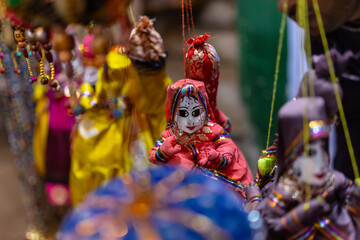 Interior decoration, Handmade colorful hanging puppets for decoration on display at shop. Selective...