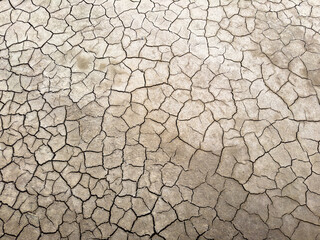 Close-up of dry, cracked earth surface showing drought effect. Ideal for concepts related to climate change, arid landscapes, and environmental issues.