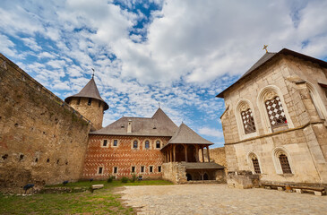 Fototapeta premium Ancient fortress in Khotyn in morning sun with mist, West Ukraine. Fortification on the banks of the Dniester River, one of the most famous and largest castles in Ukraine.