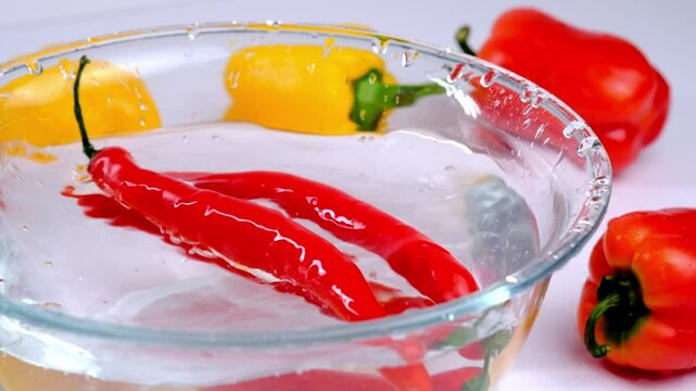 juicy red and yellow peppers in water