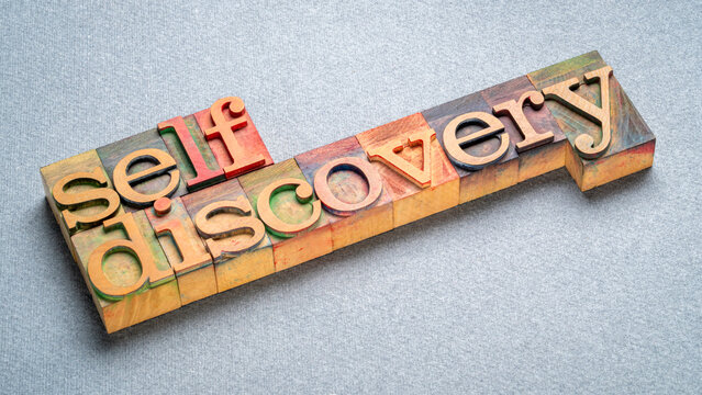 self discovery text in letterpress wood type, exploring, learning, setting goals and personal development concept
