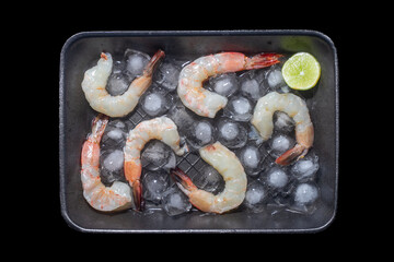 Fresh shrimps prawns seafood lemon lime with herbs and spice, Shrimp peeled on wooden board dark background dining table food, top view. copy space.