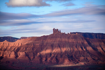 Breathtaking landscape view at sunrise near Moab, Utah, featuring a red rock mesa bathed in warm morning light. Captures the essence of natural beauty and tranquility in the American Southwest - USA