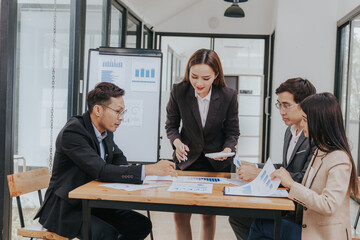 Business team analyzing financial charts and marketing project planning They use technology to participate in productive meetings. Brainstorming and effective communication for growth and success.