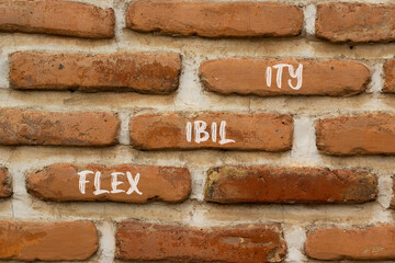 Flexibility symbol. Concept word Flexibility on beautiful brown bricks. Beautiful brown brick wall...