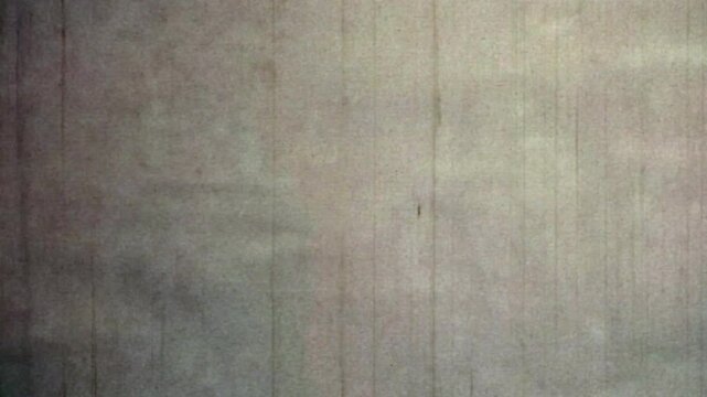 Retro gray abstract filmstrip background. Empty loop old movie texture. Looping analog film. Reel scratches, dirty, noise moving. Vintage monochrome film scan. Retro 1960s 8mm archive. 4k backdrop