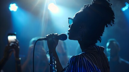 African American singer on stage with a microphone in the light of a spotlight