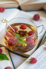 Fruit red tea with berries in glass cup on white background