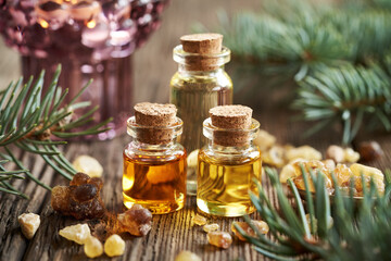 Christmas selection of essential oils with frankincense resin and spruce tree