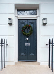 Victorian Door in London, England with a Traditional Christmas Wreath and Railings.