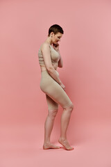 A woman with short hair stands in a bra, a symbol of breast cancer prevention and awareness.