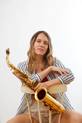 portrait of girl with saxophone seated