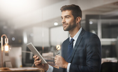 Fototapeta premium Businessman, smile and thinking with tablet in office for problem solving, brainstorming or employee for research. Professional, designer and thoughtful with tech for digital project ideas at night