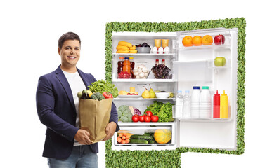 Young man with a grocery bag and eco friendly fridge