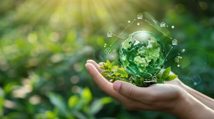 A hand holding a globe and recycling icon on a green background