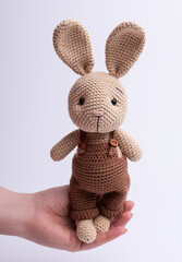 Handmade knitted amigurumi bunny toy.