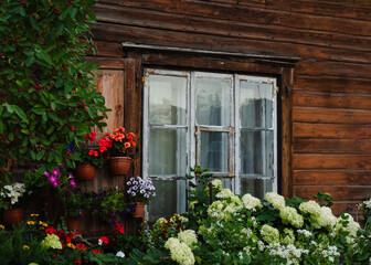 Rustic Wooden House with Flowers