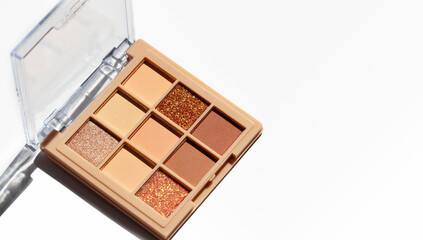 Makeup palette on white. Professional makeup eyeshadow palette in beige and brown shades.