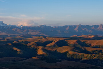 Russia, the Elbrus region. Stunning dawn view of the Caucasus mountains from the cliffs of the Bolshoy Bermamyt plateau.