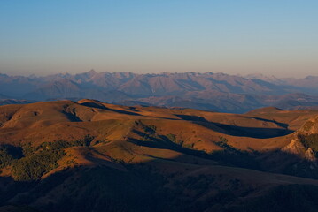 Russia, the Elbrus region. Stunning dawn view of the Caucasus mountains from the cliffs of the Bolshoy Bermamyt plateau.