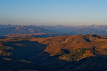 Russia, the Elbrus region. Stunning dawn view of the Caucasus mountains from the cliffs of the Bolshoy Bermamyt plateau.