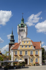 Fototapeta premium Exterior facade of the town hall (Rathaus) and Grosse Str. in Verden an der Aller, Lower Saxony, Germany. Summer view with blue sky and copy space above.