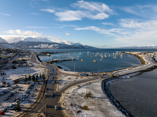 Aerial view of the city of Ushuaia. View of the bay with boats.