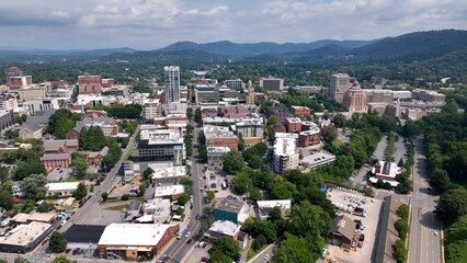 City skyline of Asheville, NC at the base of the Blue Ridge Mountains in North Carolina, a living and vacation destination in the Southern, United States showing architecture of buildings and streets