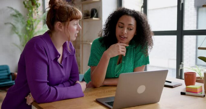 Generation Z Females talking and using Laptop in Loft Warehouse conversion