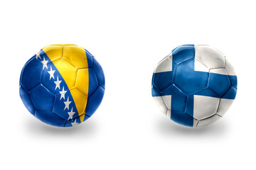 football balls with national flags of finland and bosnia and herzegovina,soccer teams. on the white background.