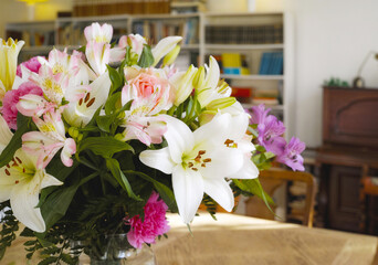 Flowers, home and eco friendly decor for growth in environment, sustainable and house plants. Daffodils, vase and green for natural design or furniture in apartment, leaves and blooming indoor