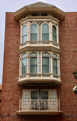 old brick building with decorative bay windows
