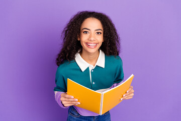 Photo of nice young girl hold opened copybook wear shirt isolated on violet color background