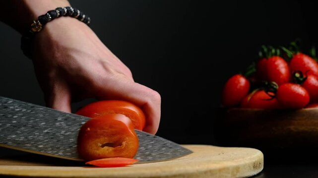 cut a tomato on a black background