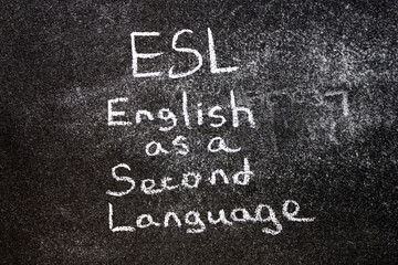 Fototapeta premium ESL English second language. ESL text written in chalk on the blackboard.