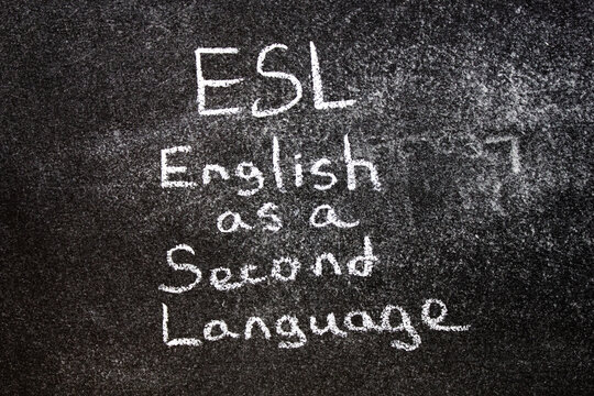 ESL English second language. ESL text written in chalk on the blackboard.