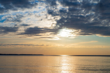 Sunset over the sea. Reflection of sunlight in the sea waves. The sky in the sunset rays. Baltic Sea.
