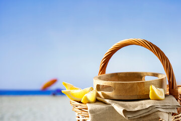 Fototapeta premium Empty summer picninc basket on sunny tropical sandy beach with copy space for products and objects. Summer concept background.
