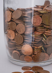 coins in a glass jar close-up. save money