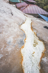 Mineral hot spring Garm Chashma breaks out of the rocks and flows down the cliff forming a small stream