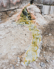 Mineral hot spring Garm Chashma paints rocks in different colors in Tajikistan in Pamir