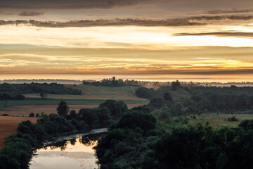 Golden sky, river, forest and fog