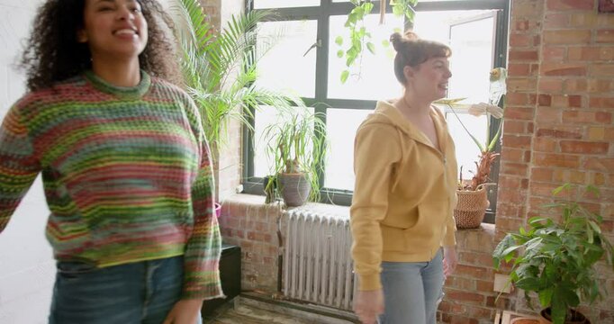 Two Female Friends carrying Boxes, Roommates Moving into a Flat share