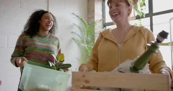 Two Female Friends carrying Boxes, Roommates Moving into a Flat share