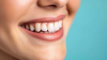 Fototapeta premium Close Up of a Woman Smiling With White Teeth Against a Blue Background