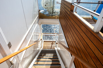 Stairs on a cruise ship with the sea in the background.