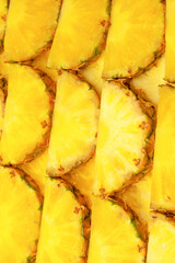 Pineapple juicy yellow slices as a background.