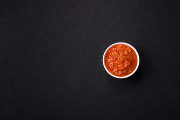 Red hot or spicy sauce with chili peppers, tomatoes, garlic, spices