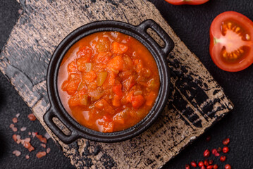 Red hot or spicy sauce with chili peppers, tomatoes, garlic, spices