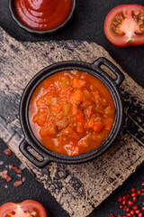 Red hot or spicy sauce with chili peppers, tomatoes, garlic, spices